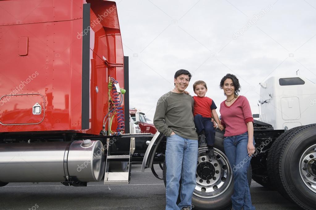 depositphotos_52027719-stock-photo-family-standing-by-their-truck