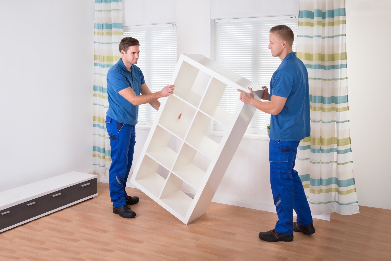 Movers Carrying Shelf At Home