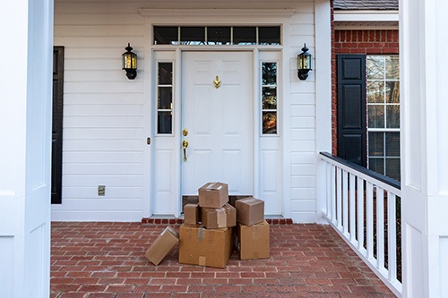 Shipping boxes on front porch of home