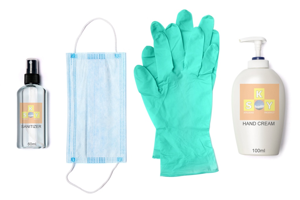 bottle of cream, lotion, sanitizer or liquid soap, latex rubber glover and protective mask isolated on white background.