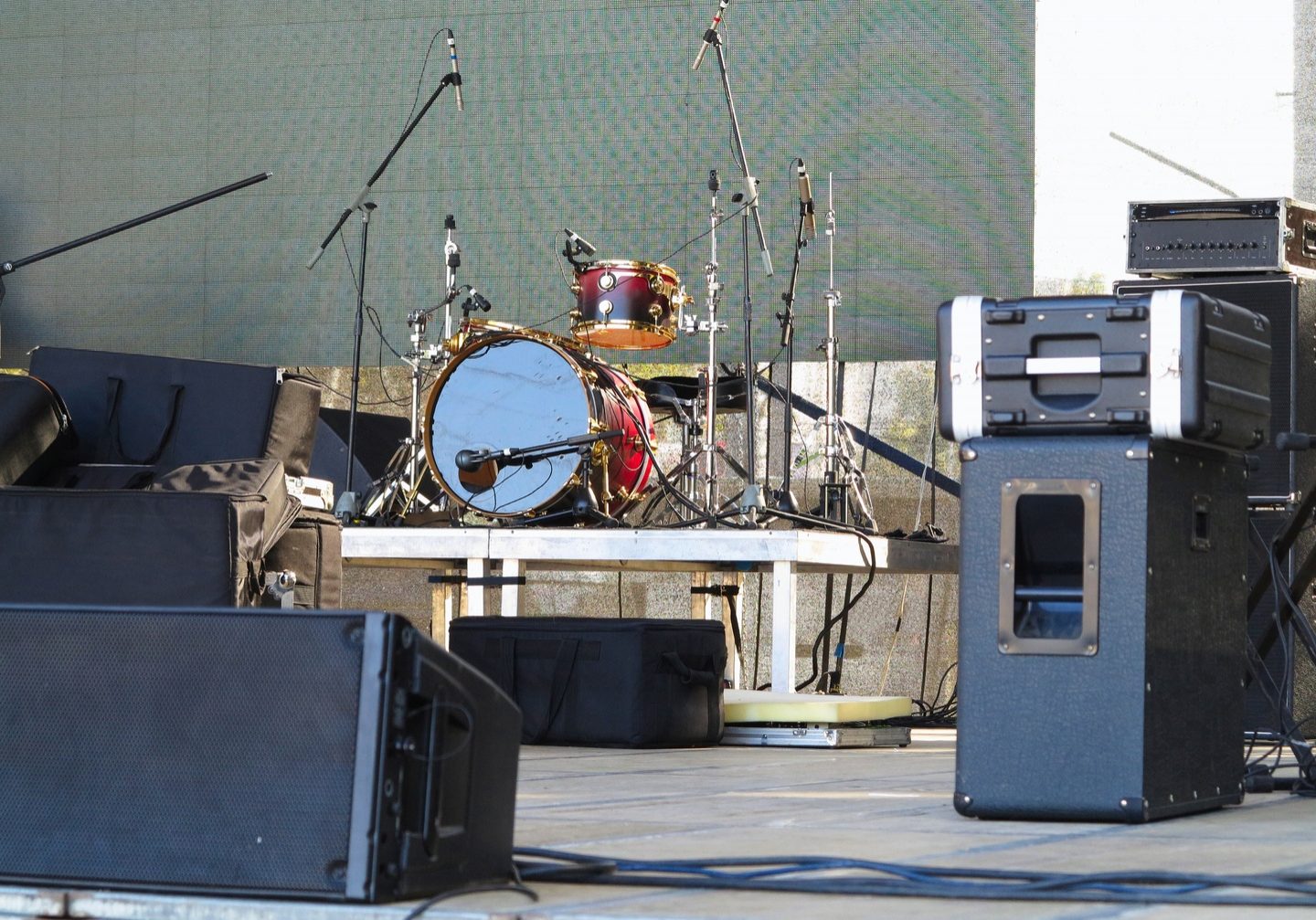 Drum set, microphones and speakers on stage ready for concert