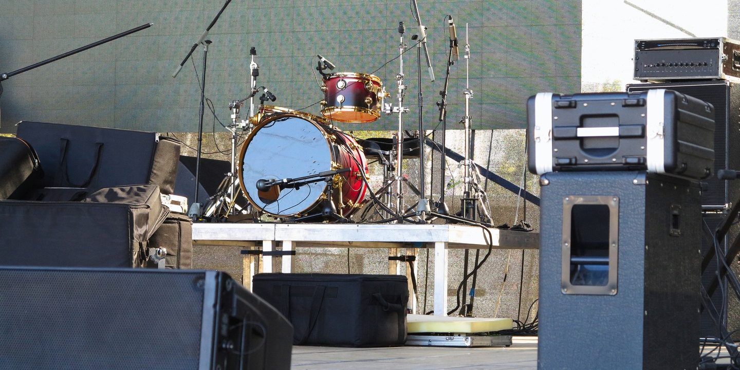 Drum set, microphones and speakers on stage ready for concert