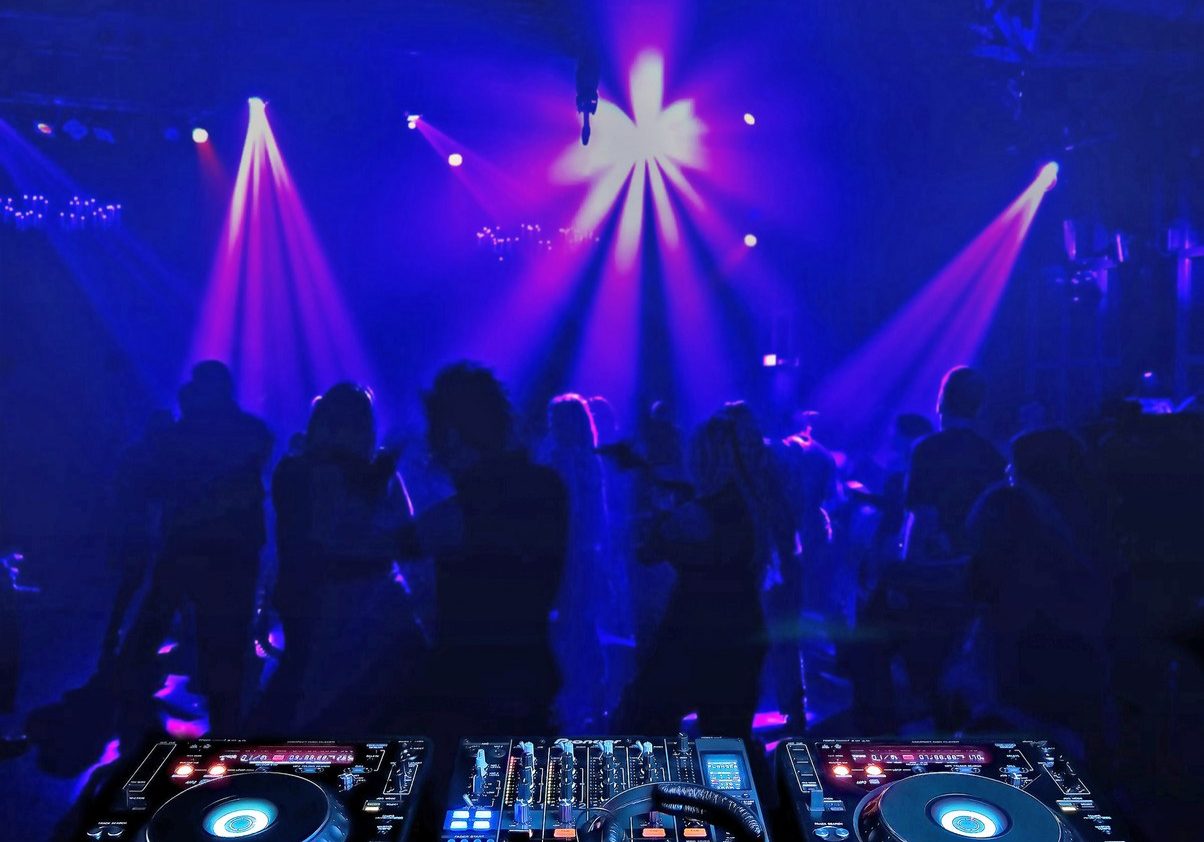 dj mixer and people in nightclub