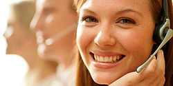 Smiling woman wearing telephone headset
